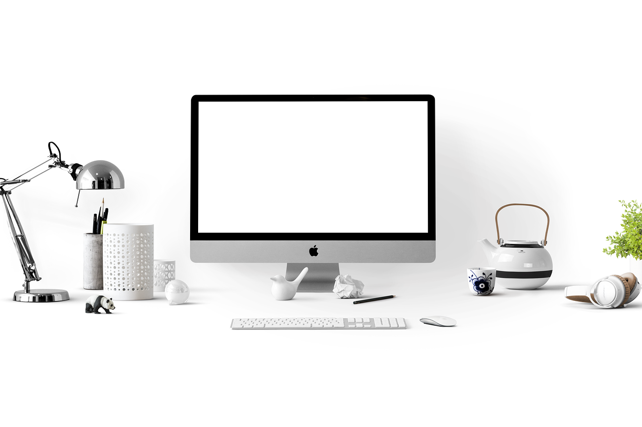 Monitor stand desk setup with organized keyboard and workspace