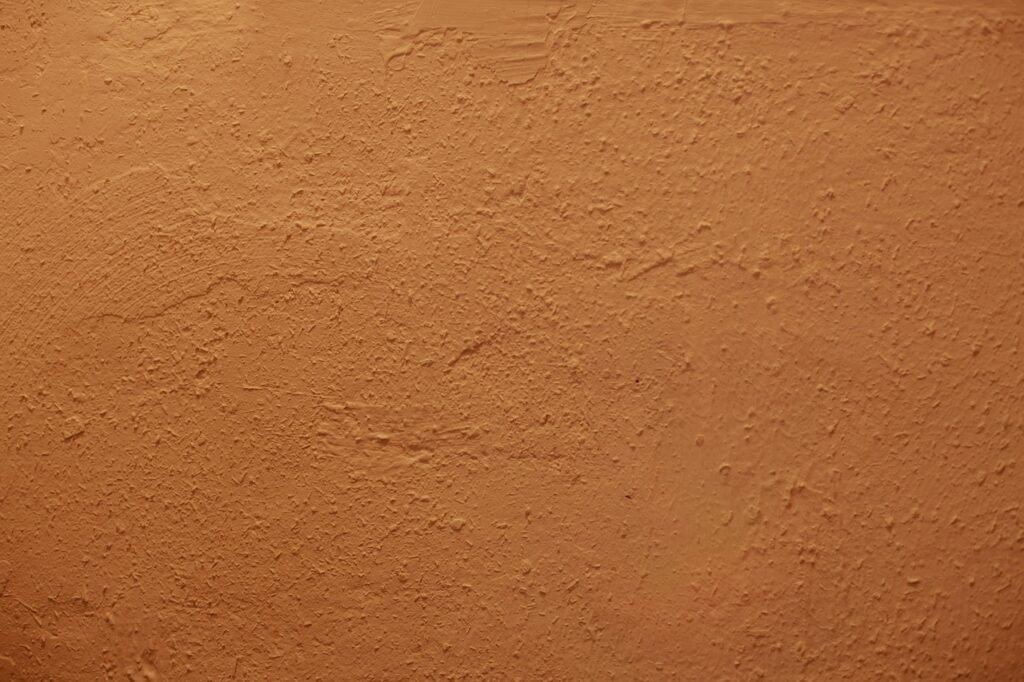 Terracotta-colored textured plaster wall