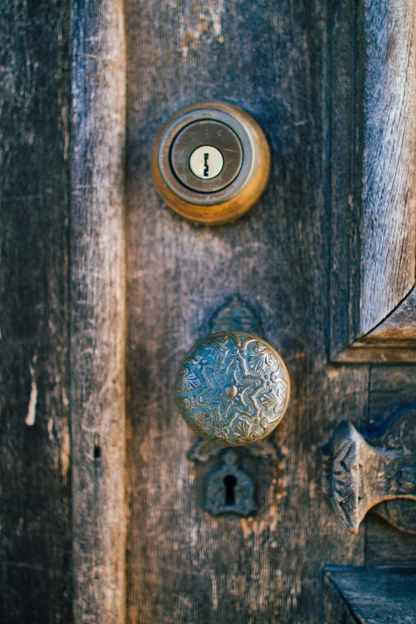 Detail of mixed metal door handle hardware on closet door