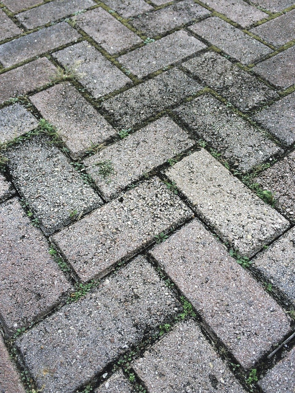 Brick paver pattern driveway base before patio installation