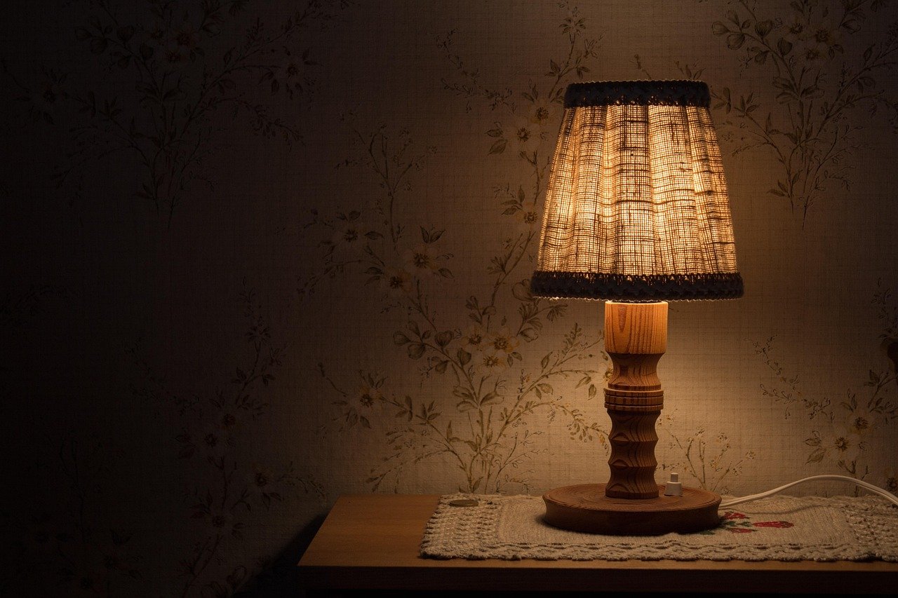 Warm table lamp glowing on a side table
