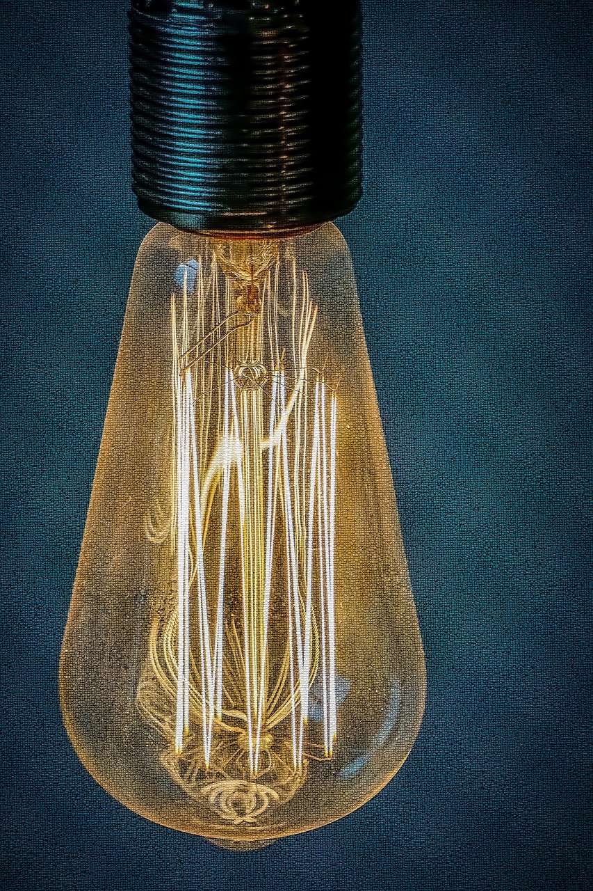 Retro stained glass style light bulb glowing