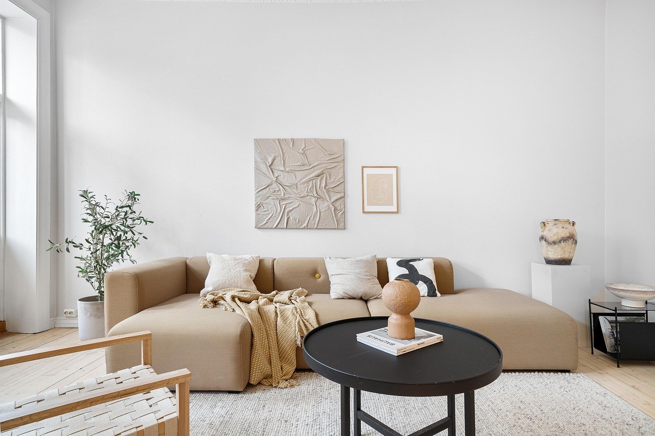 Cozy sofa with throw blanket and pillows