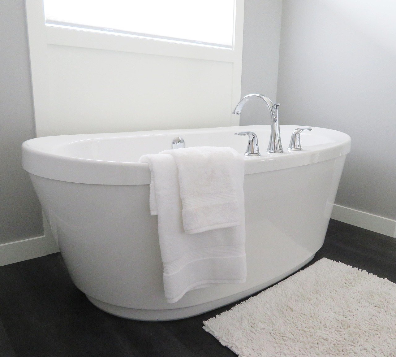 Clean white bathtub in a small bathroom