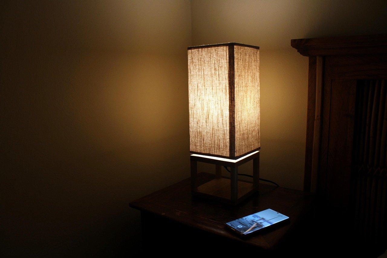 Bedside table lamp illuminating a bedroom at night