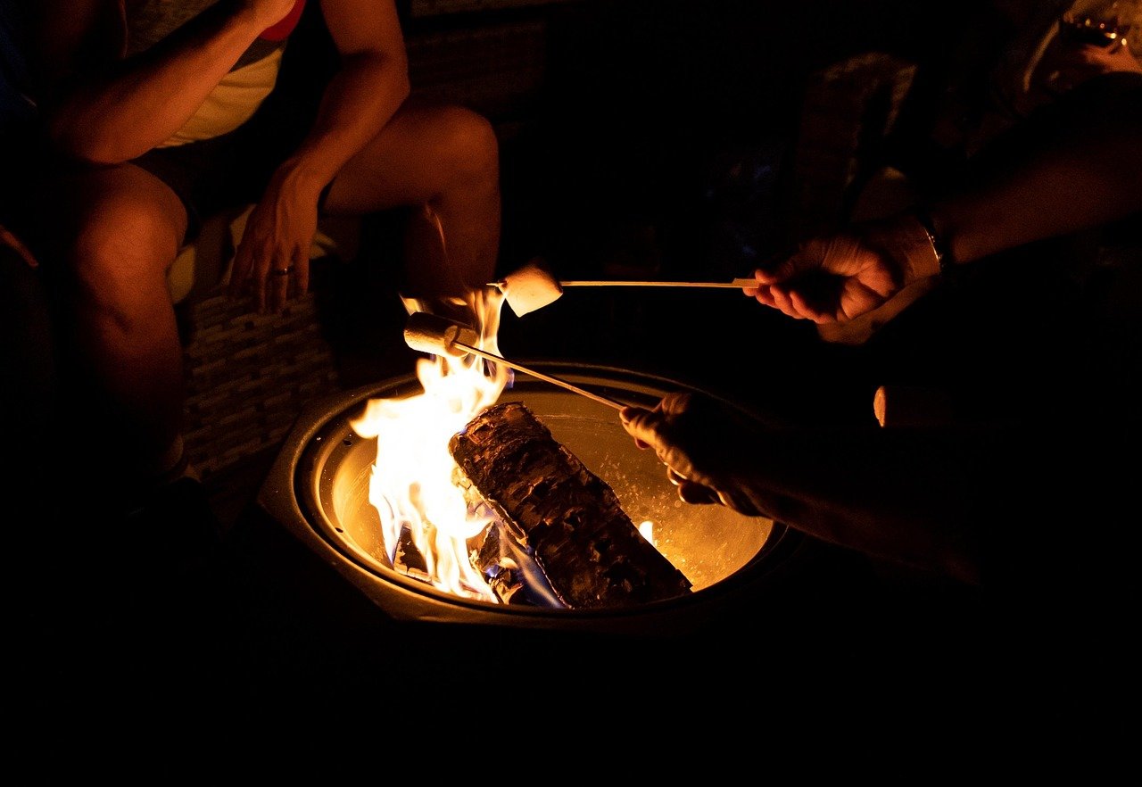 Finished fire pit patio at night with family gathered around