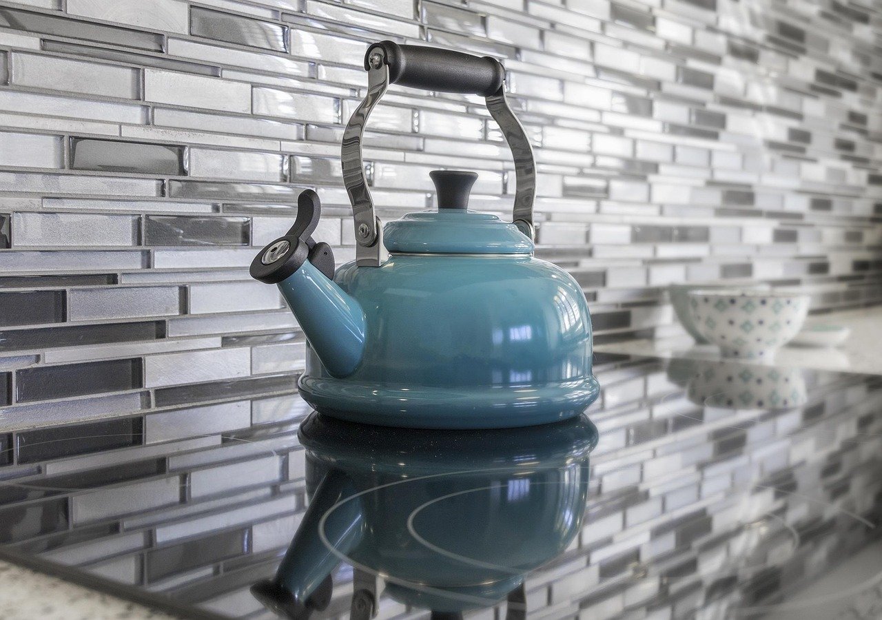 Finished mosaic tile backsplash behind a kitchen counter