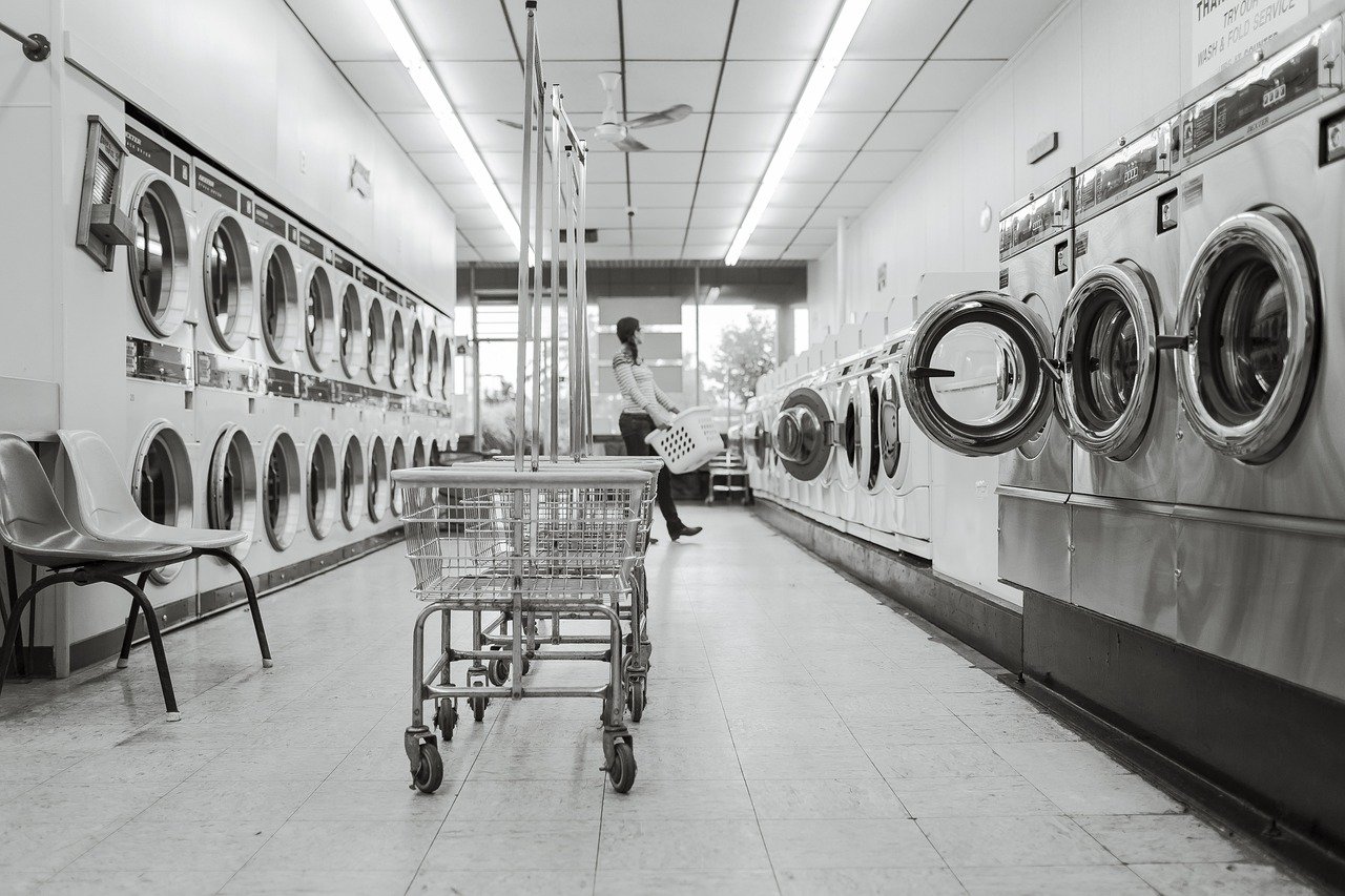 Rolling laundry cart in front of washers and dryers