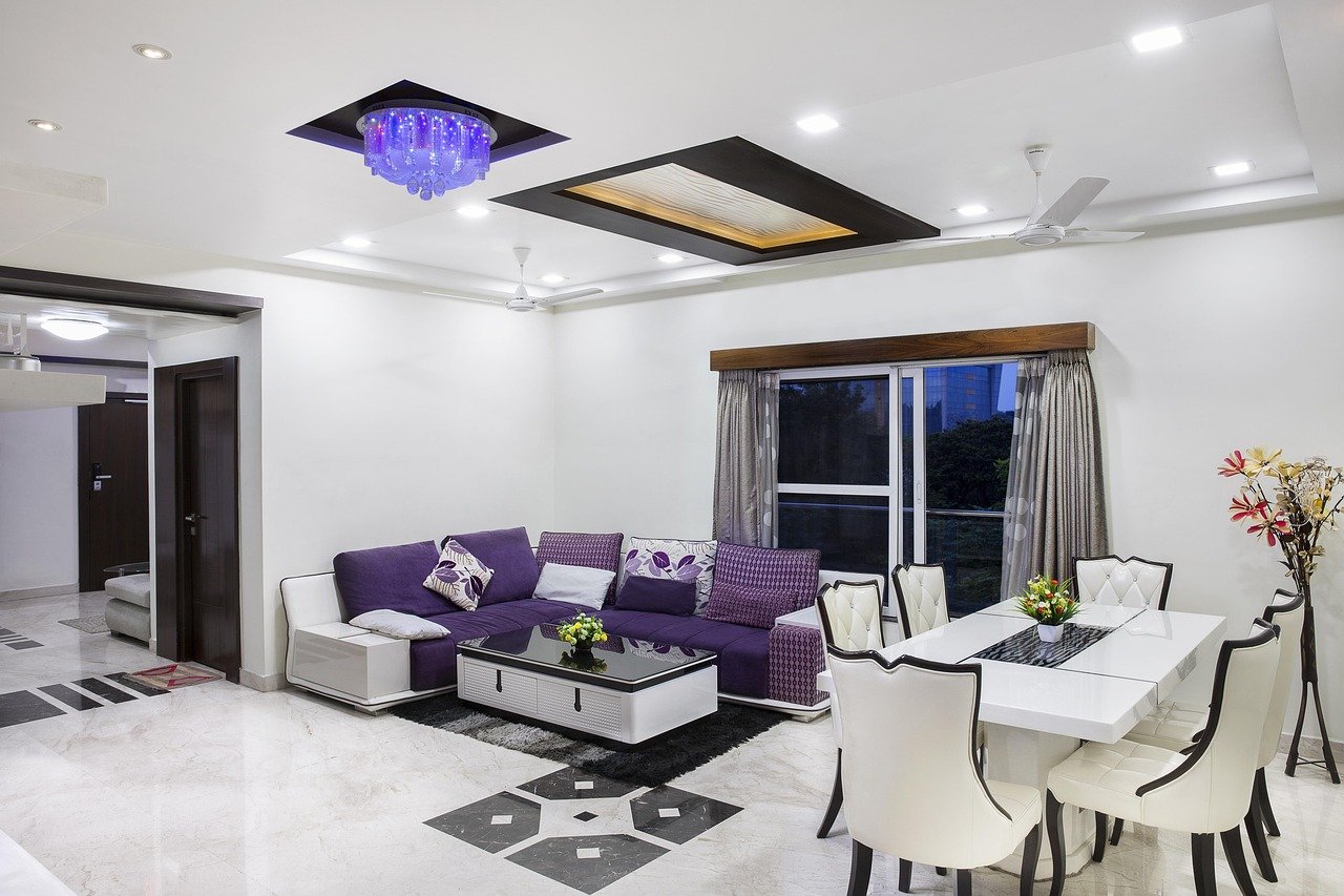 Purple sectional sofa styled in a living room corner
