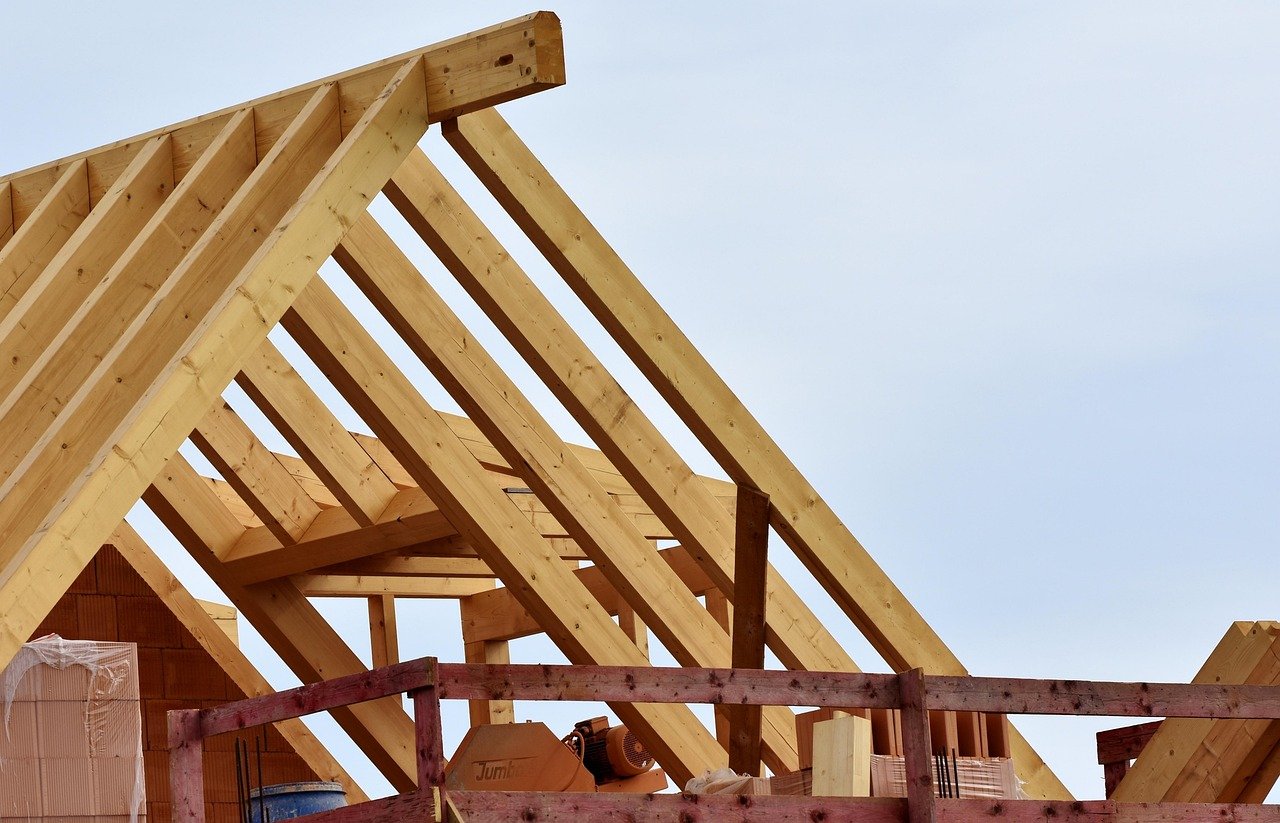 Wooden roof trusses being installed on a home under construction