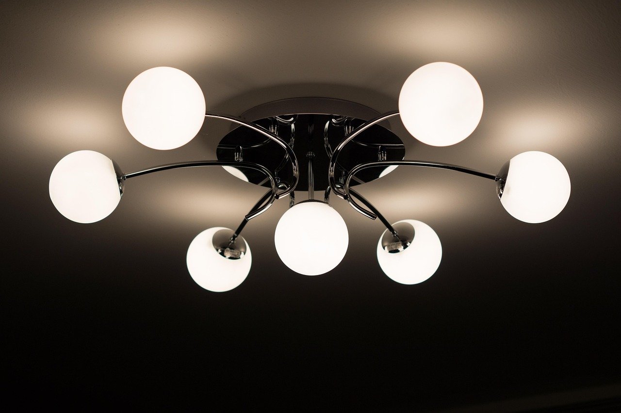 Brass chandelier hanging over a dining table