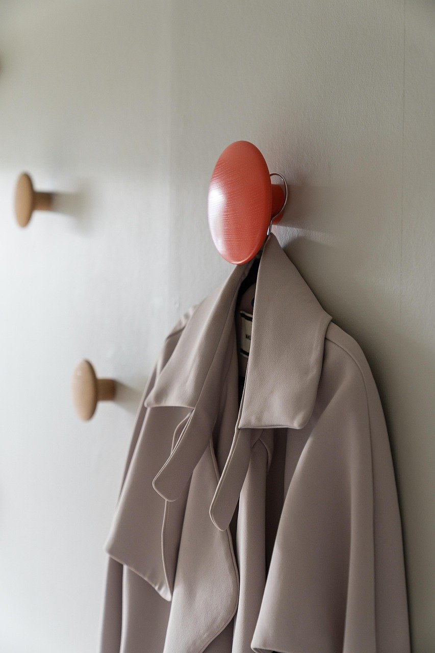 Coat and jacket hung on wall hooks