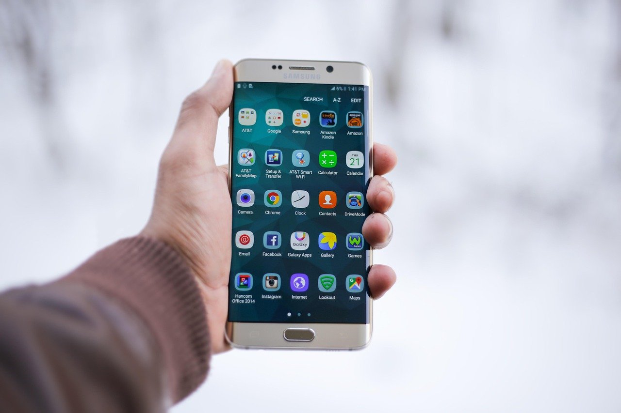 Smartphone in hand showing a home design app