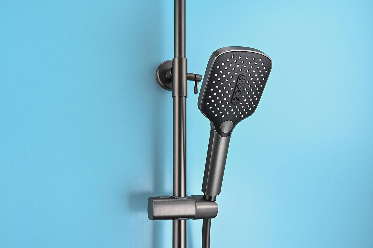 Renovated accessible bathroom with curbless shower and subtle grab bars, illustrating an aging-in-pl