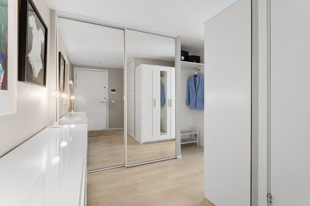 Walk-in closet with warm wood tones and built-in lighting