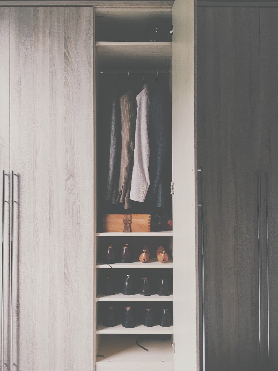Closet wardrobe with open doors showing organized storage