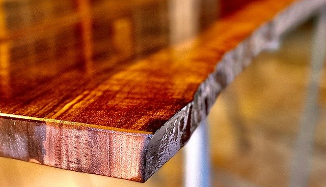 Wood table corner fitted with a clear silicone corner guard