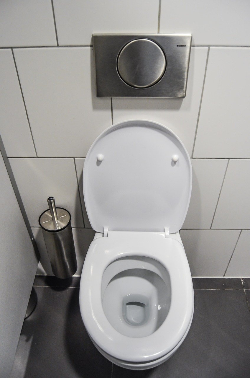 Bathroom toilet with a discreet safety lock installed under the lid