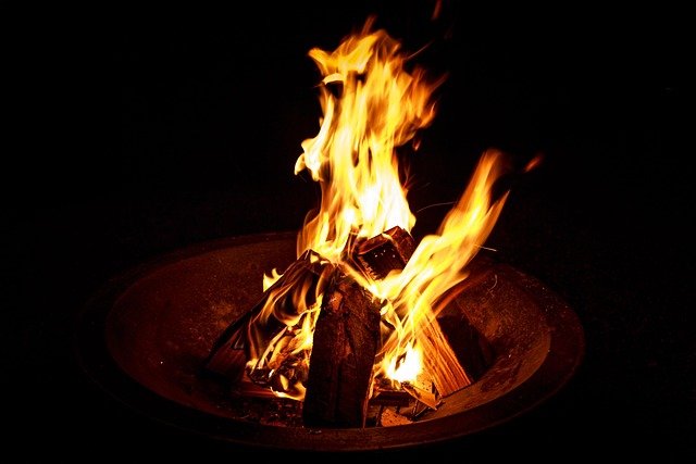 Portable metal fire bowl on stone patio