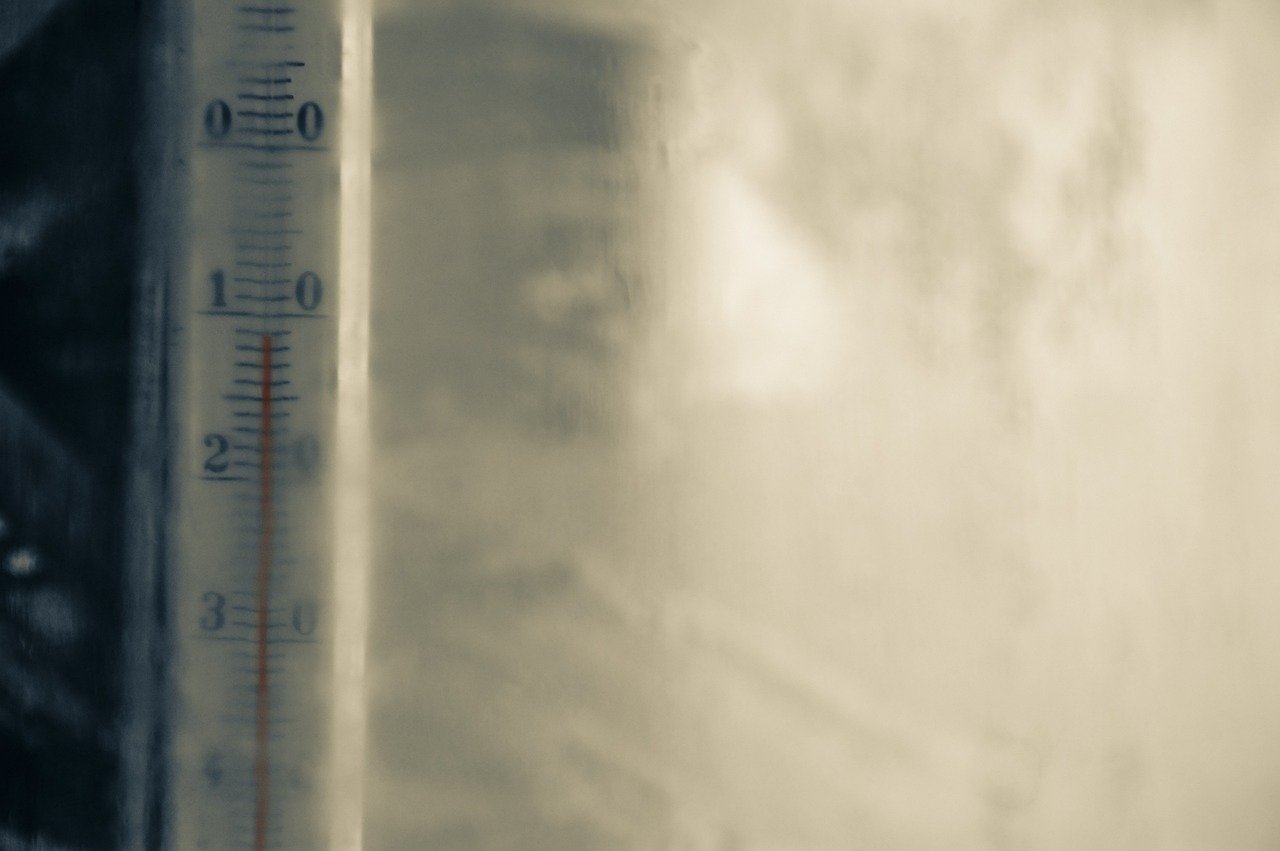 Outdoor thermometer near patio door showing temperature close to 50°F