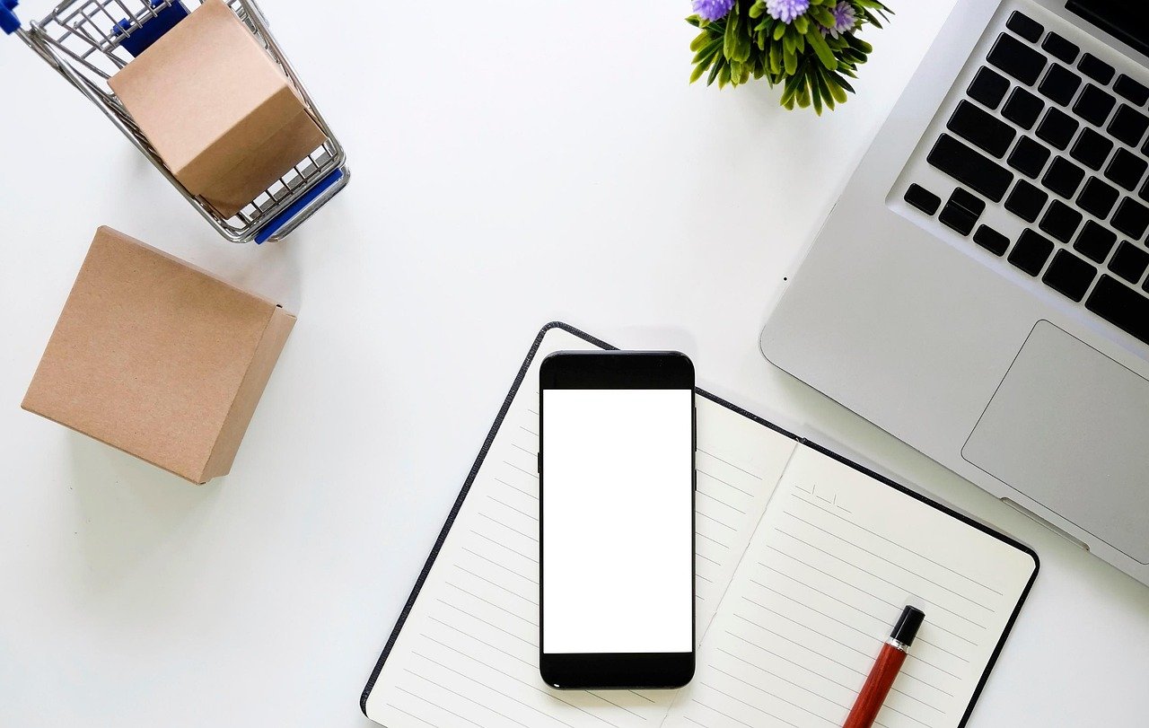 Phone and laptop on a desk ready for Prime Big Deal Days shopping