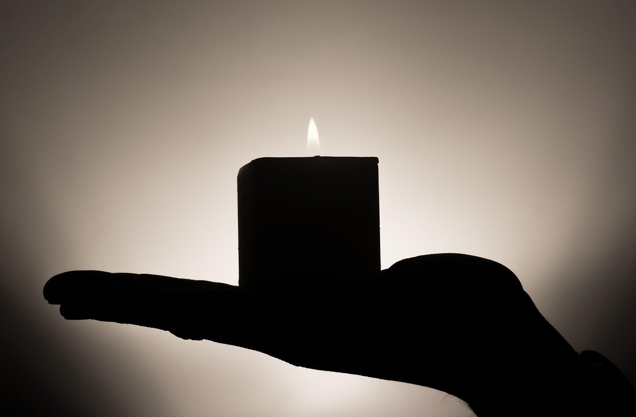 Burning candle used to check for window drafts