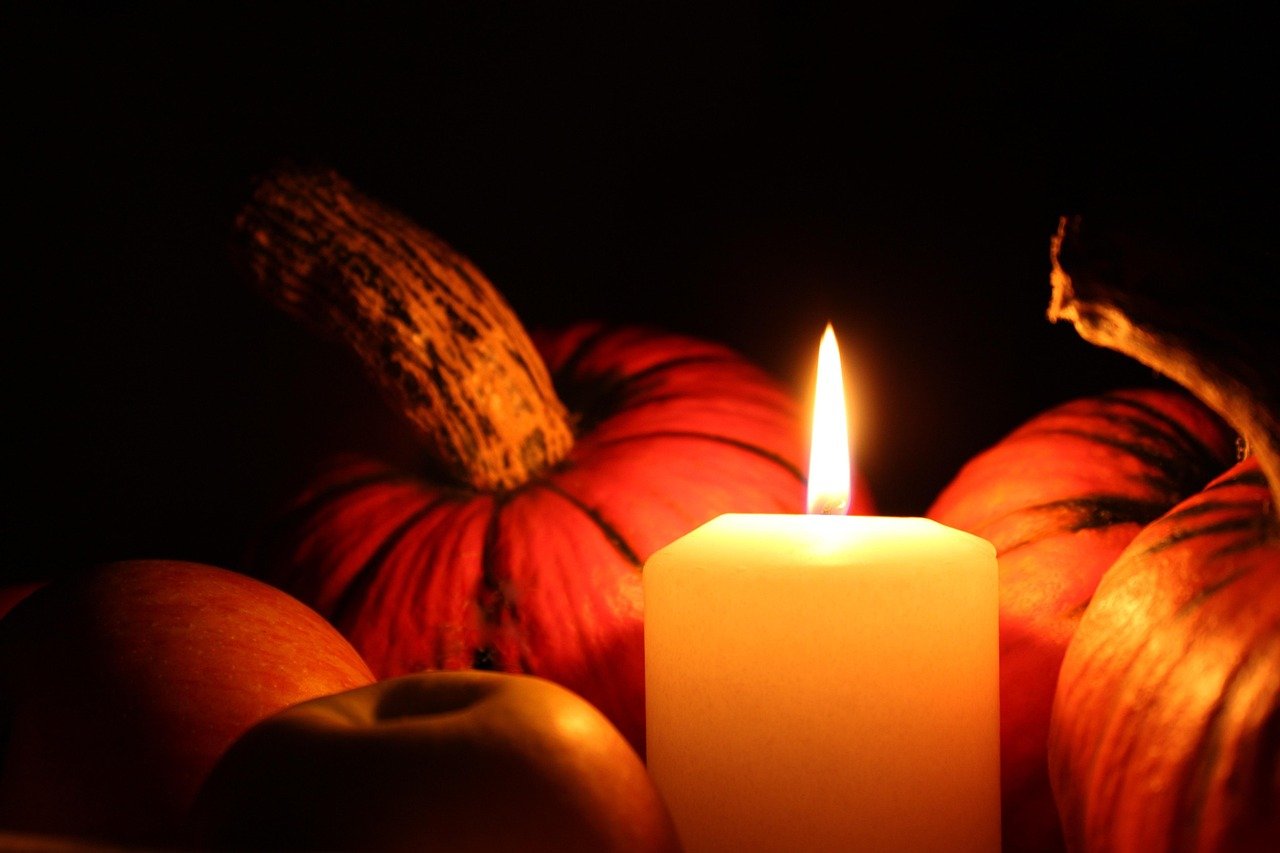 Pumpkin and candle arranged for fall decor