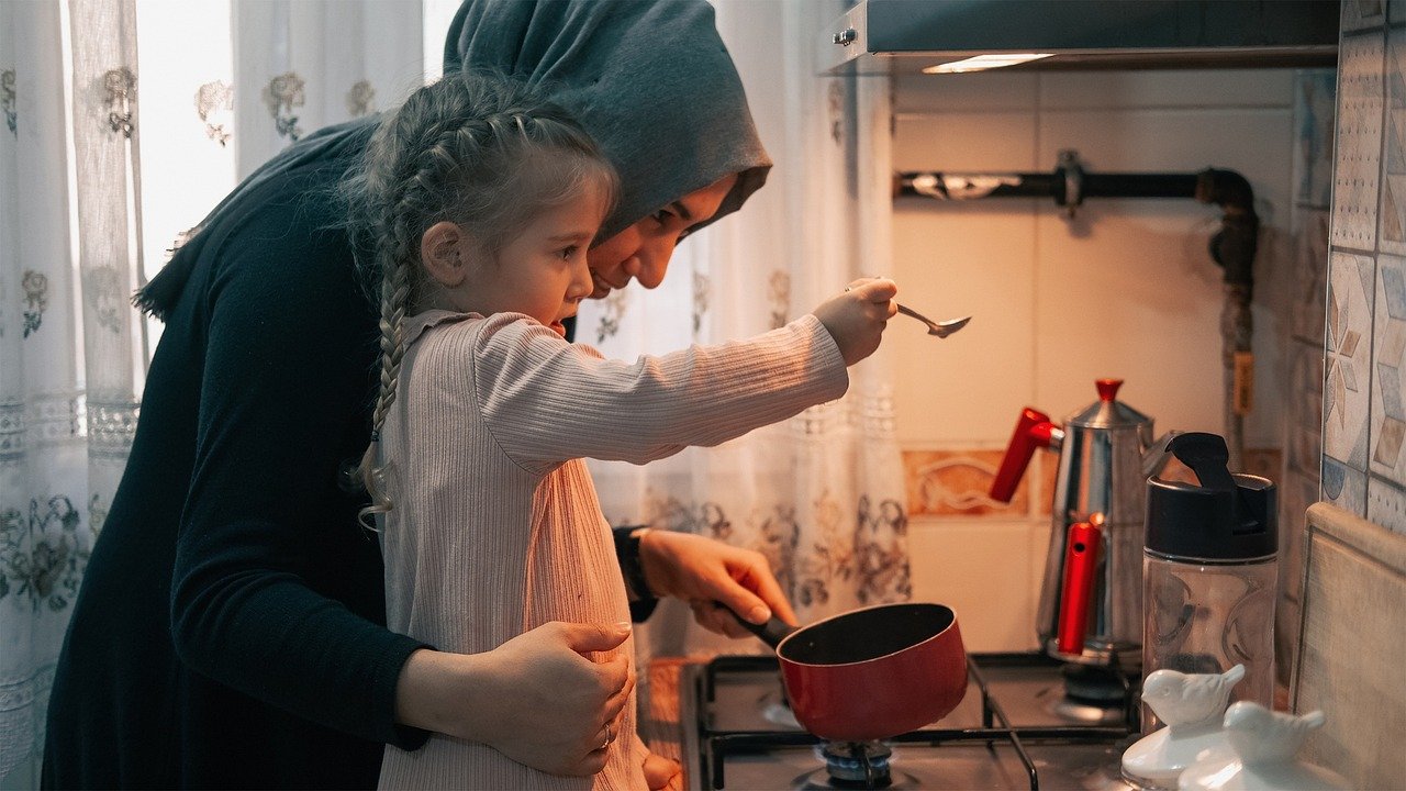 Mother and daughter cooking together