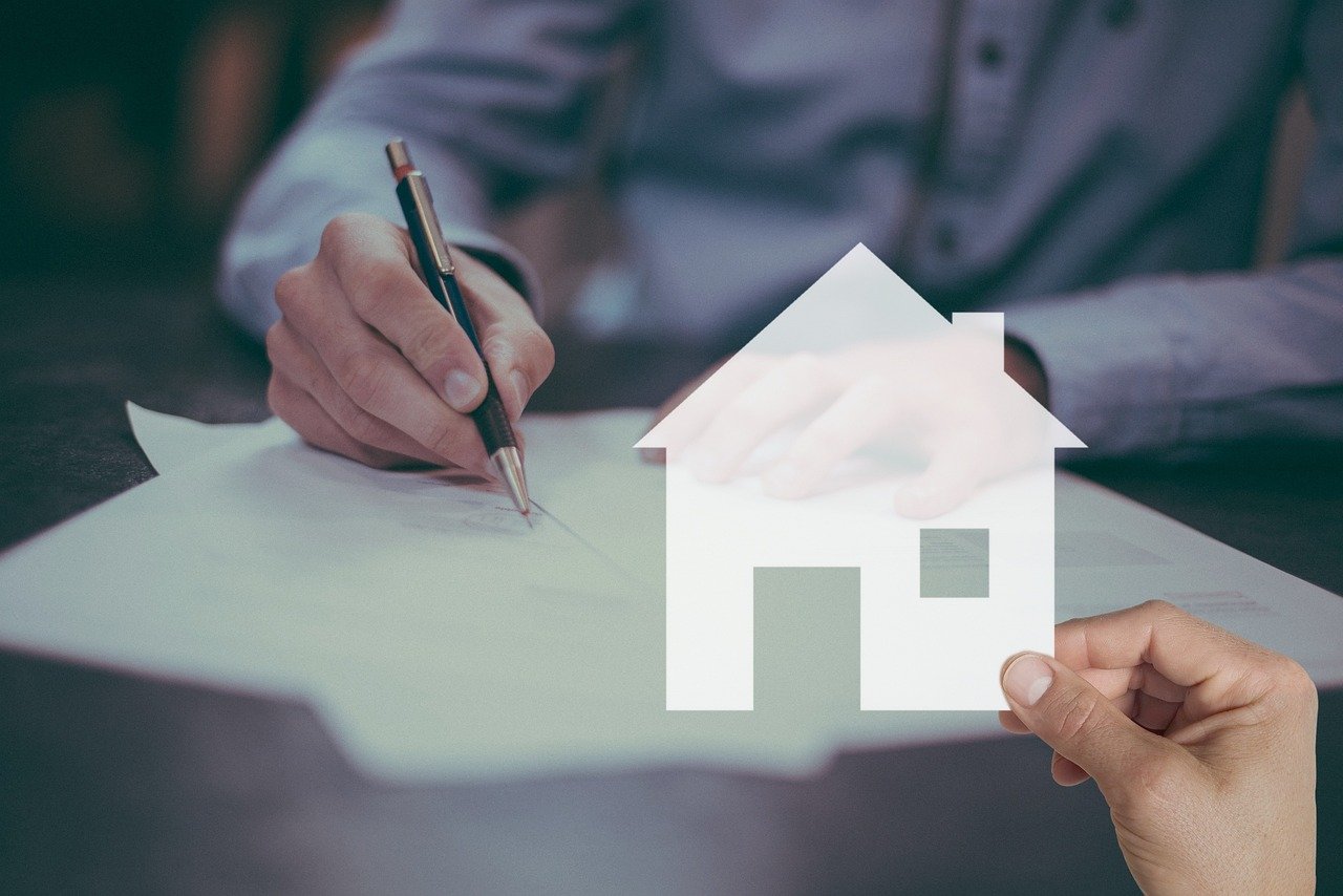 Mortgage paperwork and house-shaped keychain representing a home purchase